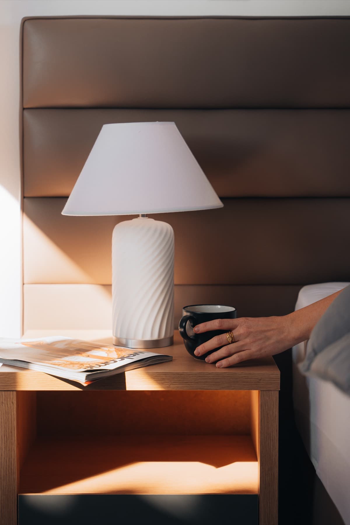 Morning light on a bedside table with coffee